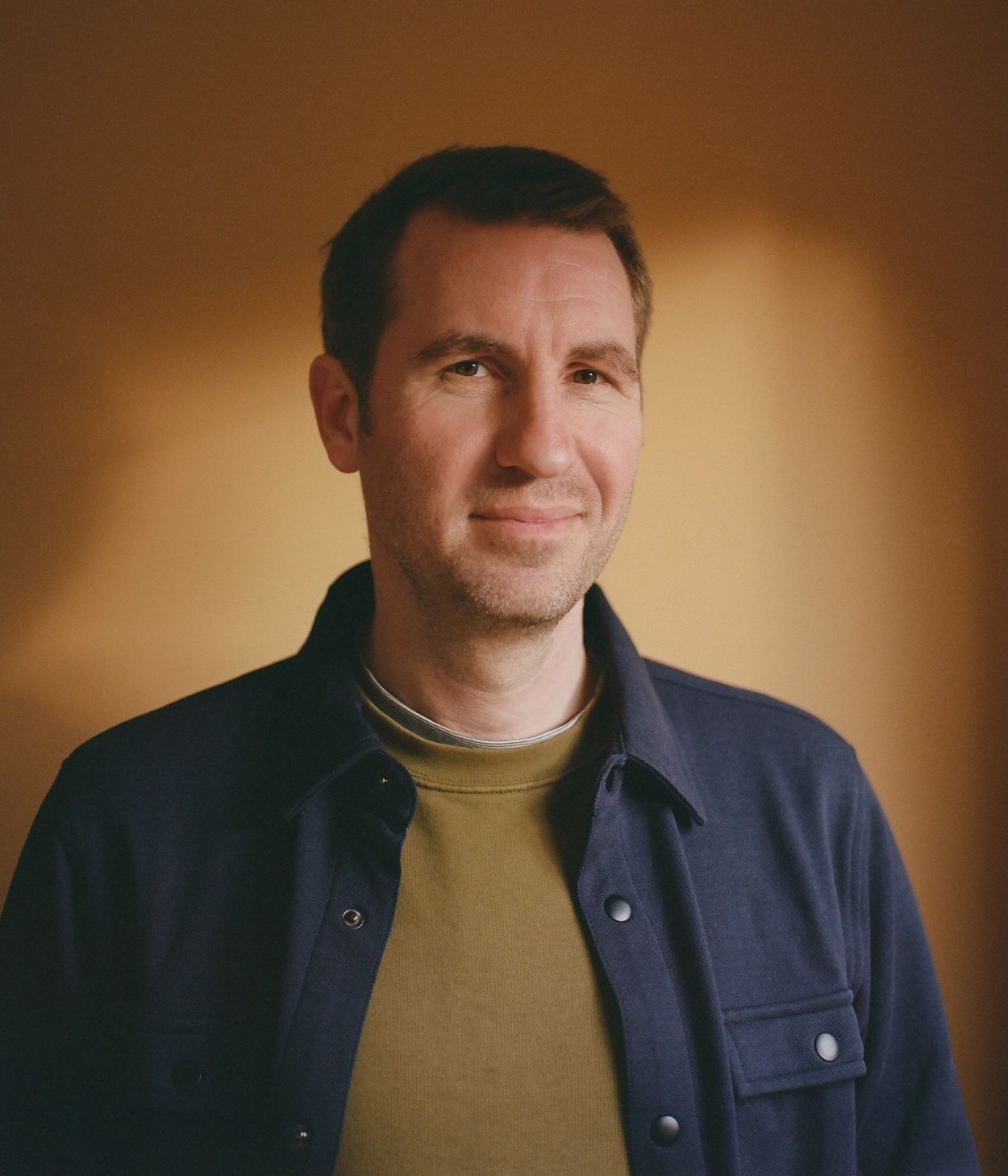 Smiling man in a warm light.