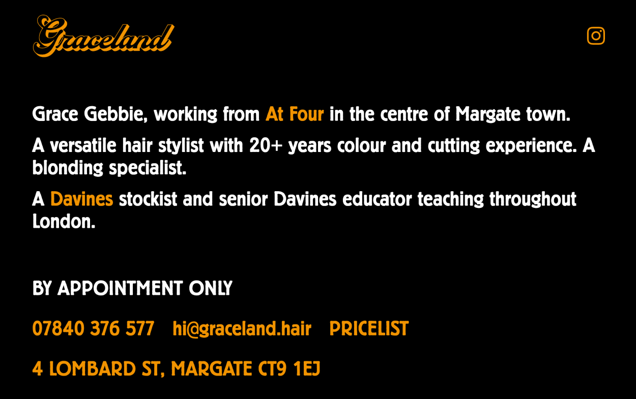 Homepage of hair salon with dark background, and white and orange text.